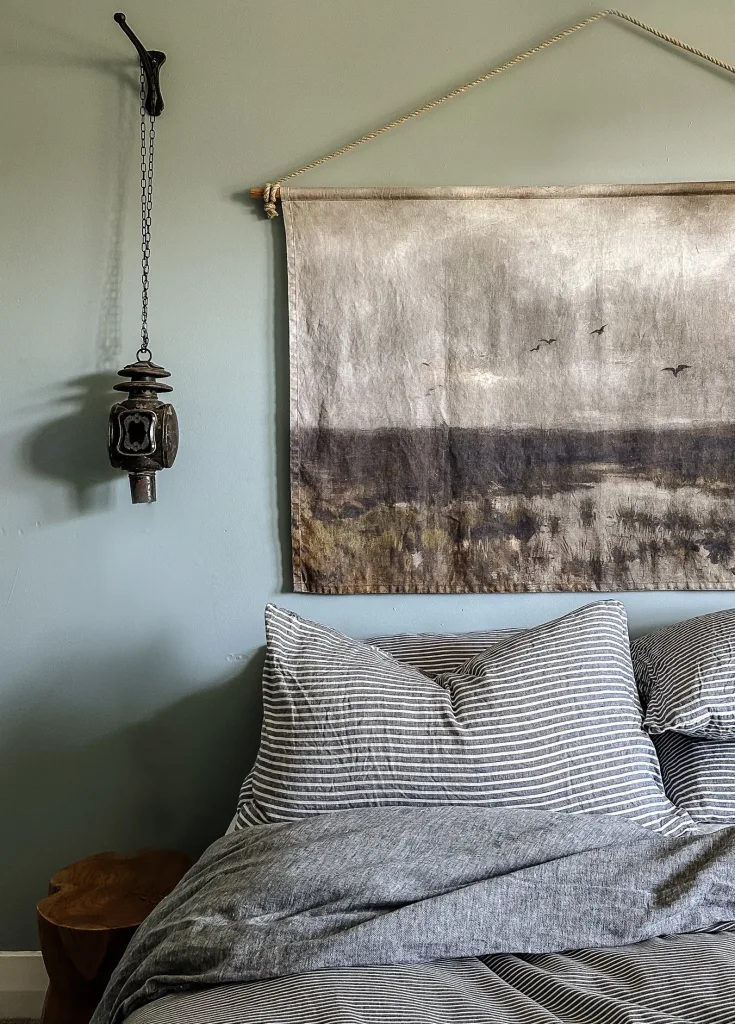 Oversized Handmade Linen Wall Hanging: Vintage Marshes Landscape Art Print above a cozy made bed with a wood end table