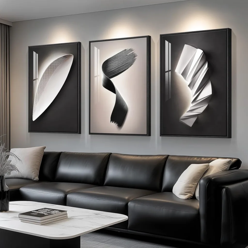 Black and White triptych oversized wall art with lighting above a black sofa in a minimalist stylish living room. Big Wall Decor Trend 2026