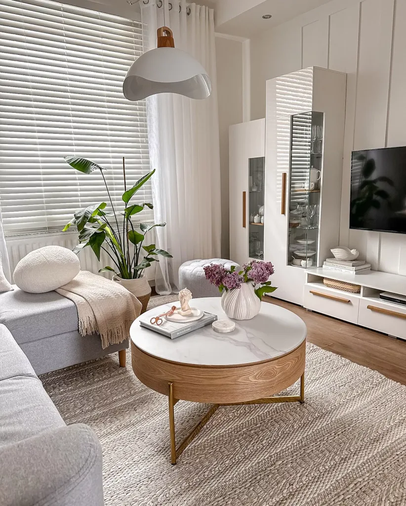 Cozy feminine living room neutral colors small space wood and marble table with area rug