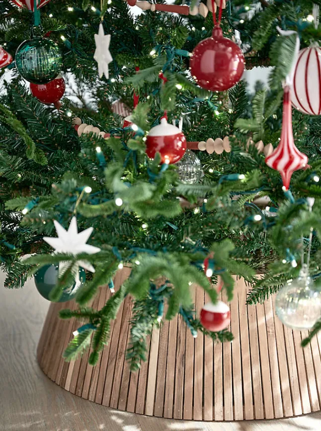 Beautiful Designer Christmas Decor Dupes You Can Buy or DIY – Classic Candy Cane Christmas Ornaments

A green Christmas tree is decorated with red-and-white candy cane ornaments, white star accents, and natural wood decorations. The traditional color palette and playful details create a cheerful, nostalgic look inspired by classic Christmas styling.