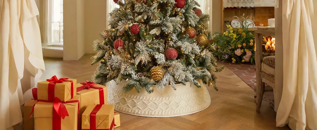 Beautiful Designer Christmas Decor Dupes You Can Buy or DIY – Rustic Woven Christmas Tree Basket

A lush evergreen Christmas tree features gold baubles and warm lights, creating a soft, inviting holiday glow. Its base is finished with a woven wicker tree collar and a green wrapped gift, adding rustic texture and an elegant finishing touch.
