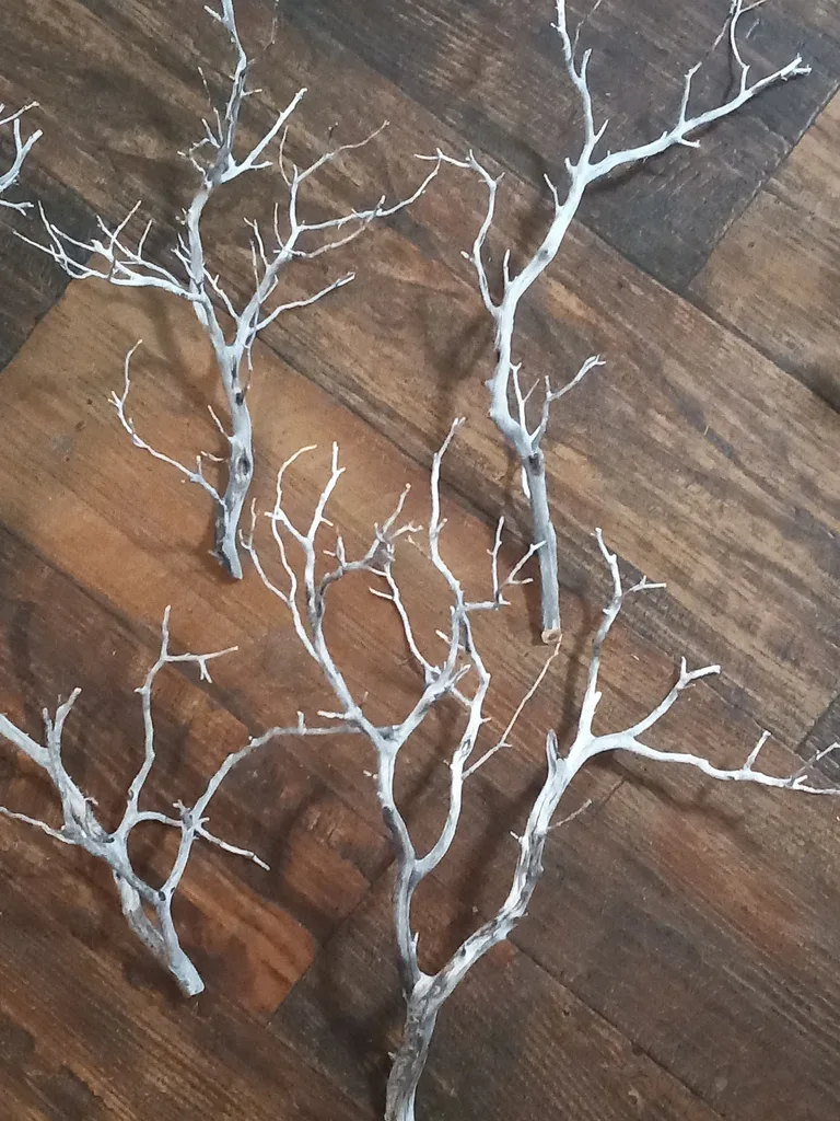 Easy Ways to Make Your Porch Feel Like Fall - A close-up of decorative white branches with a frosted, weathered finish, creating a natural, sculptural accent for autumn or winter interior decor.
