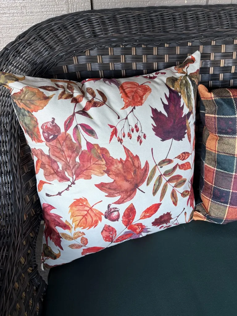 Easy Ways to Make Your Porch Feel Like Fall - soft Fall Pillow on a rattan black chair